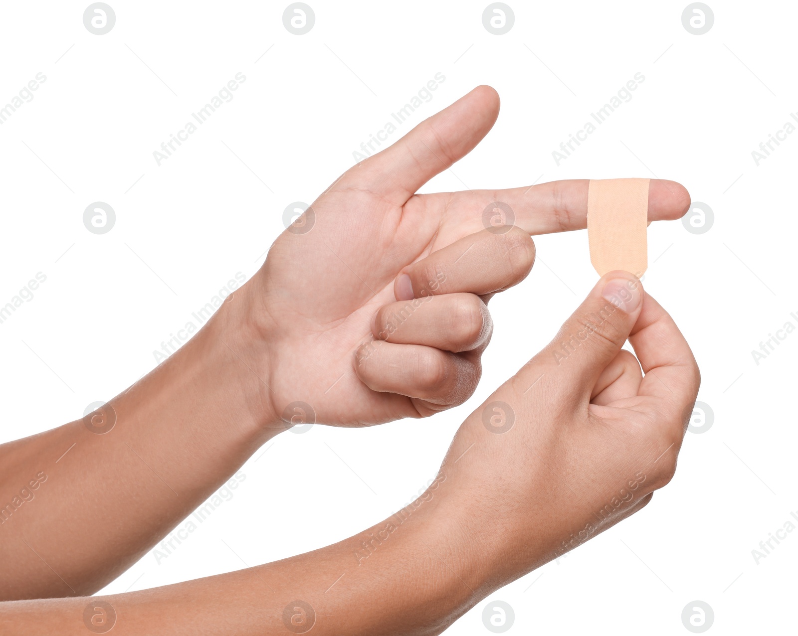 Photo of Man putting sticking plaster onto finger on white background, closeup