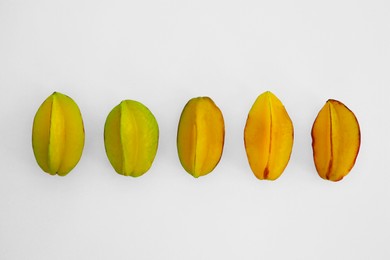 Delicious ripe carambolas on white background, top view