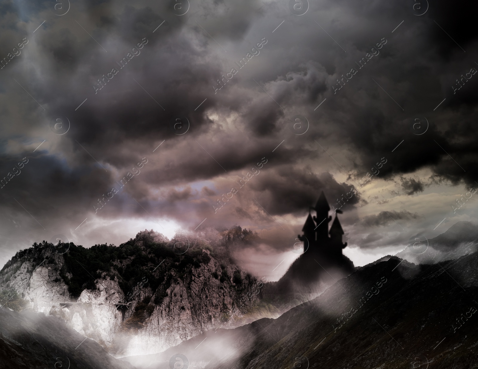 Image of Fantasy world. Mystical castle and mountains covering with fog in night