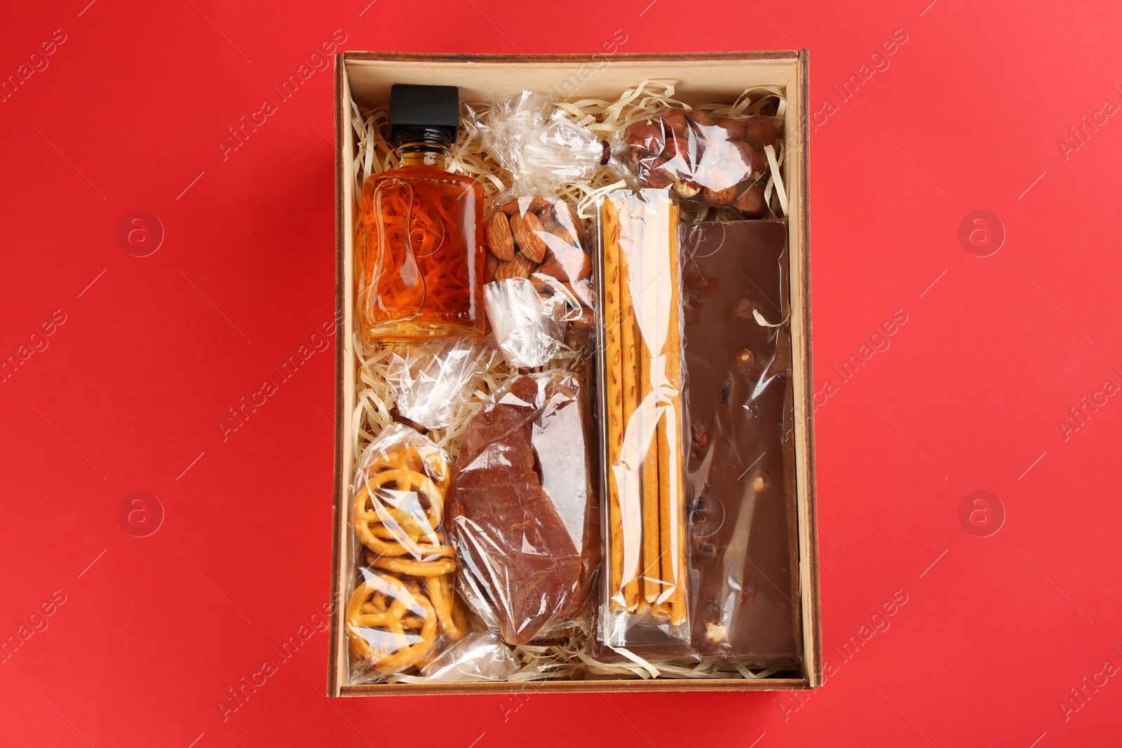 Photo of Stylish gift set on red background, top view