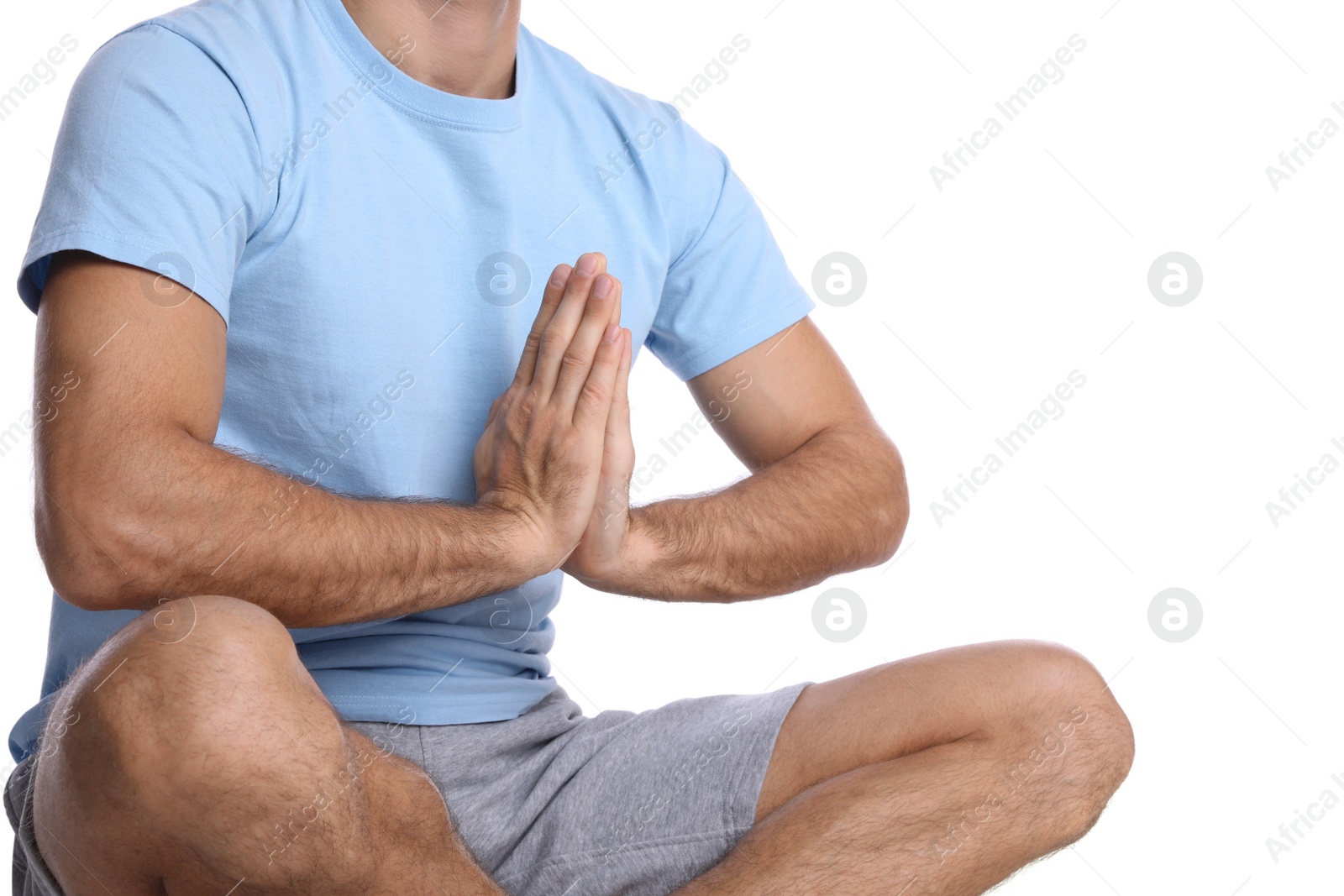 Photo of Man meditating on white background, closeup. Harmony and zen