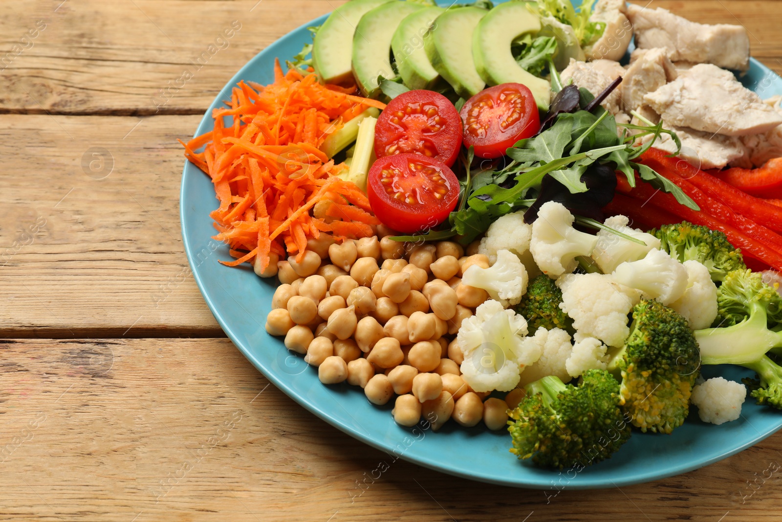 Photo of Balanced diet and healthy foods. Plate with different delicious products on wooden table, closeup