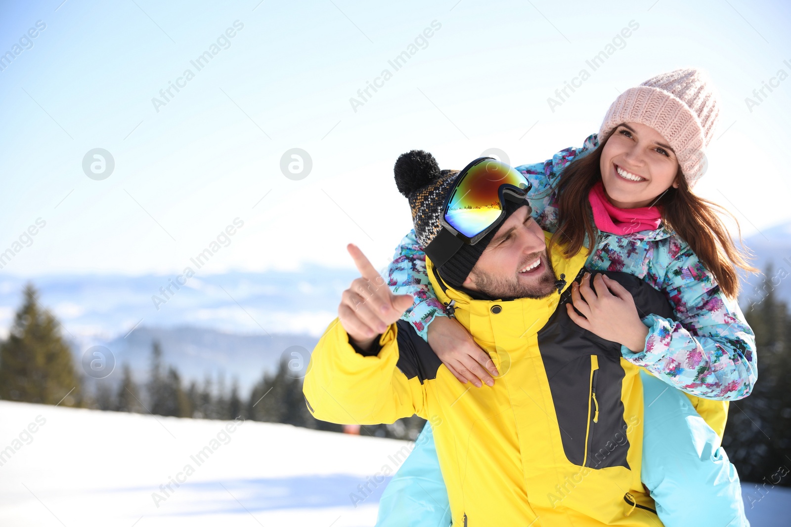 Photo of Happy young couple outdoors, space for text. Winter vacation