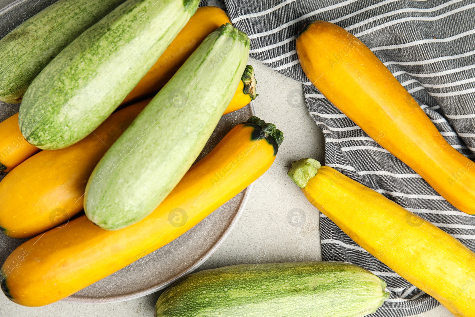 Photo of Flat lay composition with fresh ripe zucchinis on light table