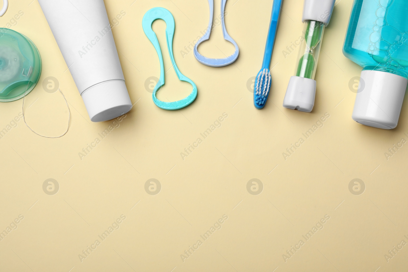 Photo of Flat lay composition with tongue cleaners and teeth care products on color background. Space for text