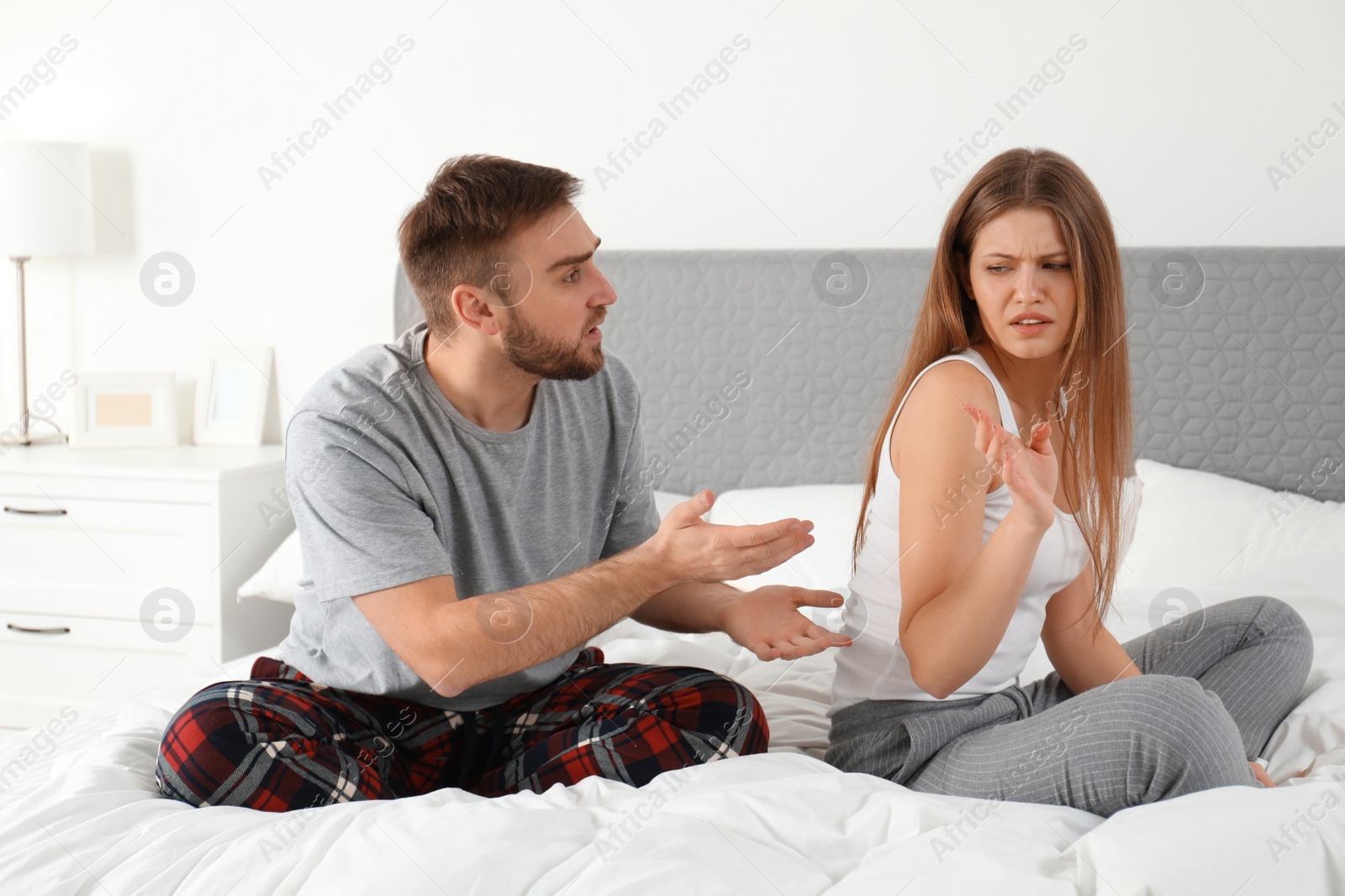 Photo of Unhappy young couple quarreling at home. Relationship problems