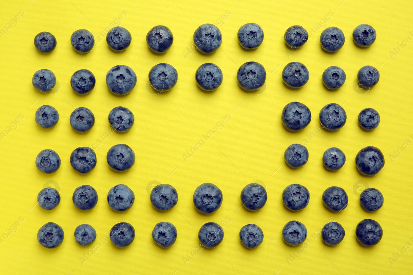 Photo of Flat lay composition with tasty blueberry and space for text on color background