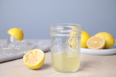 Photo of Freshly squeezed lemon juice on light table