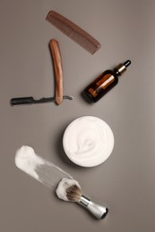 Set of men's shaving tools and foam on gray table, flat lay