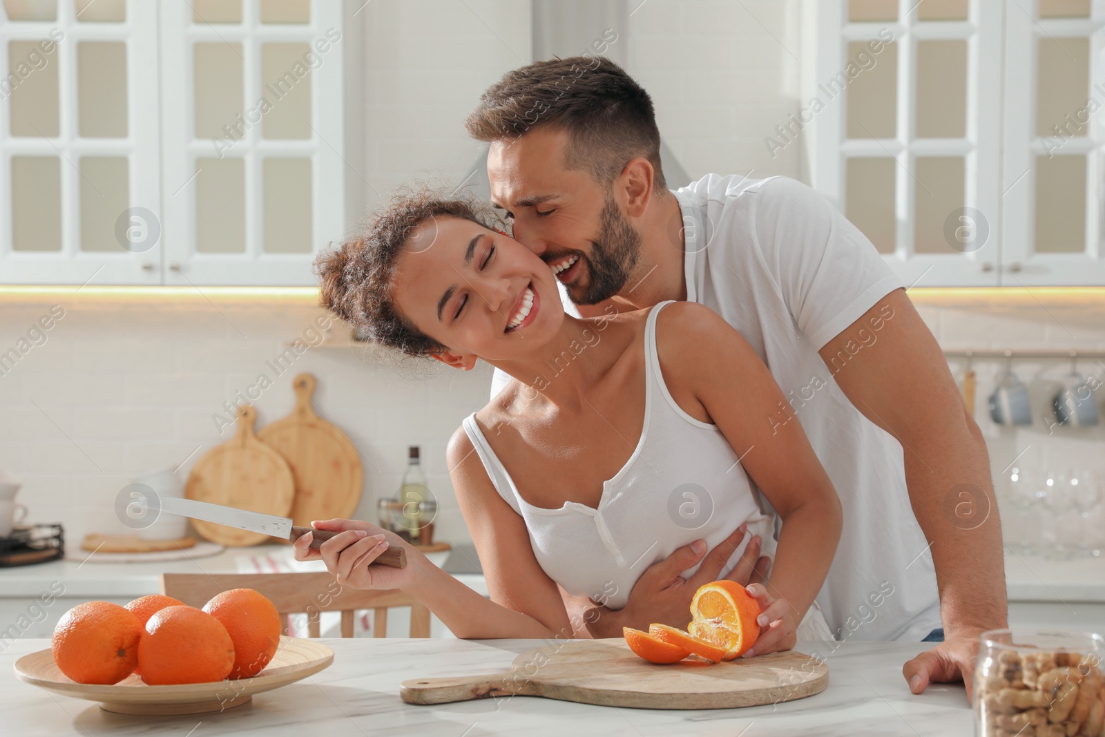 Photo of Lovely couple enjoying time together during breakfast at table in kitchen