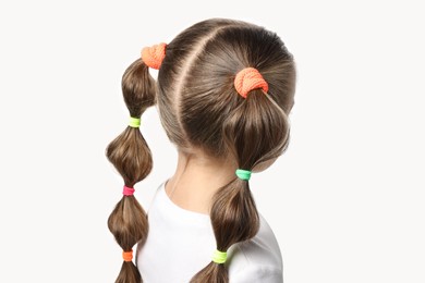 Little girl with beautiful hairstyle on white background, back view