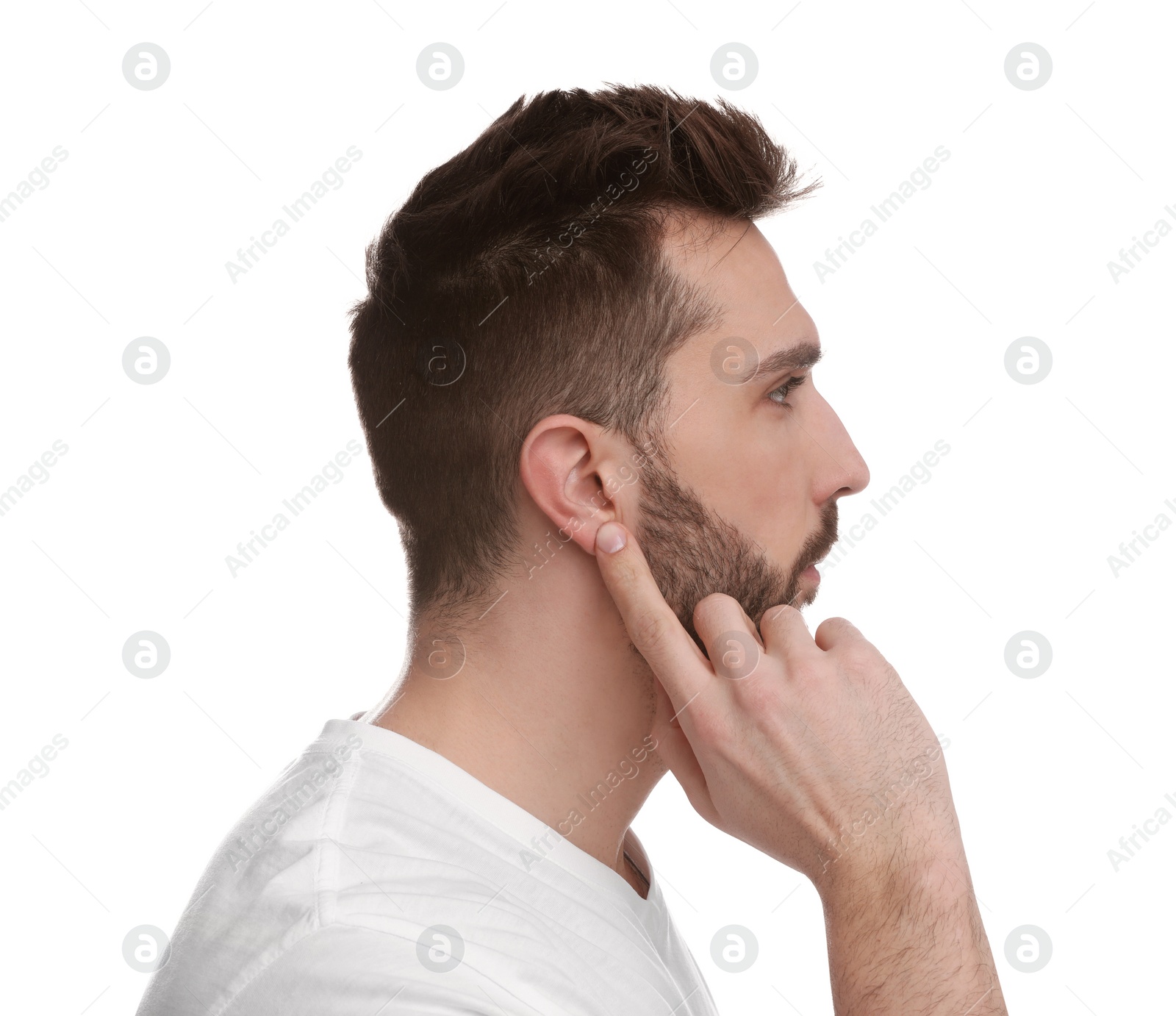 Photo of Man pointing at his ear on white background