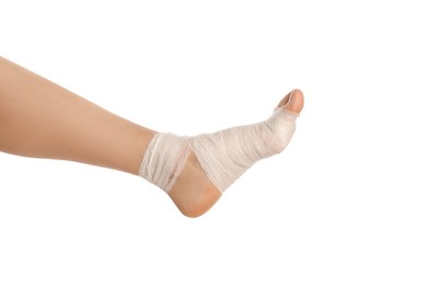 Photo of Woman with foot wrapped in medical bandage on white background, closeup