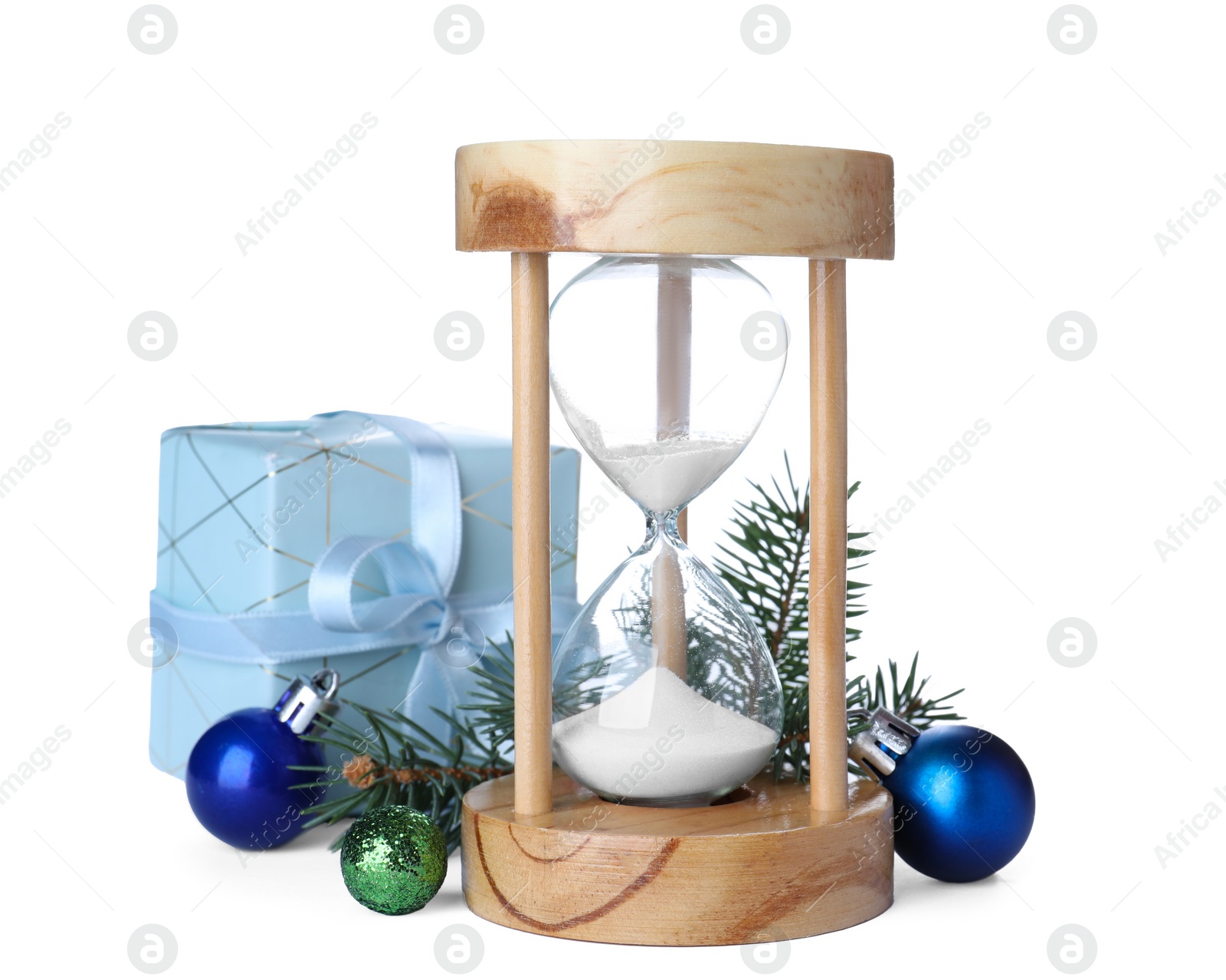 Photo of Hourglass, gift and fir tree twig with balls on white background. Christmas countdown