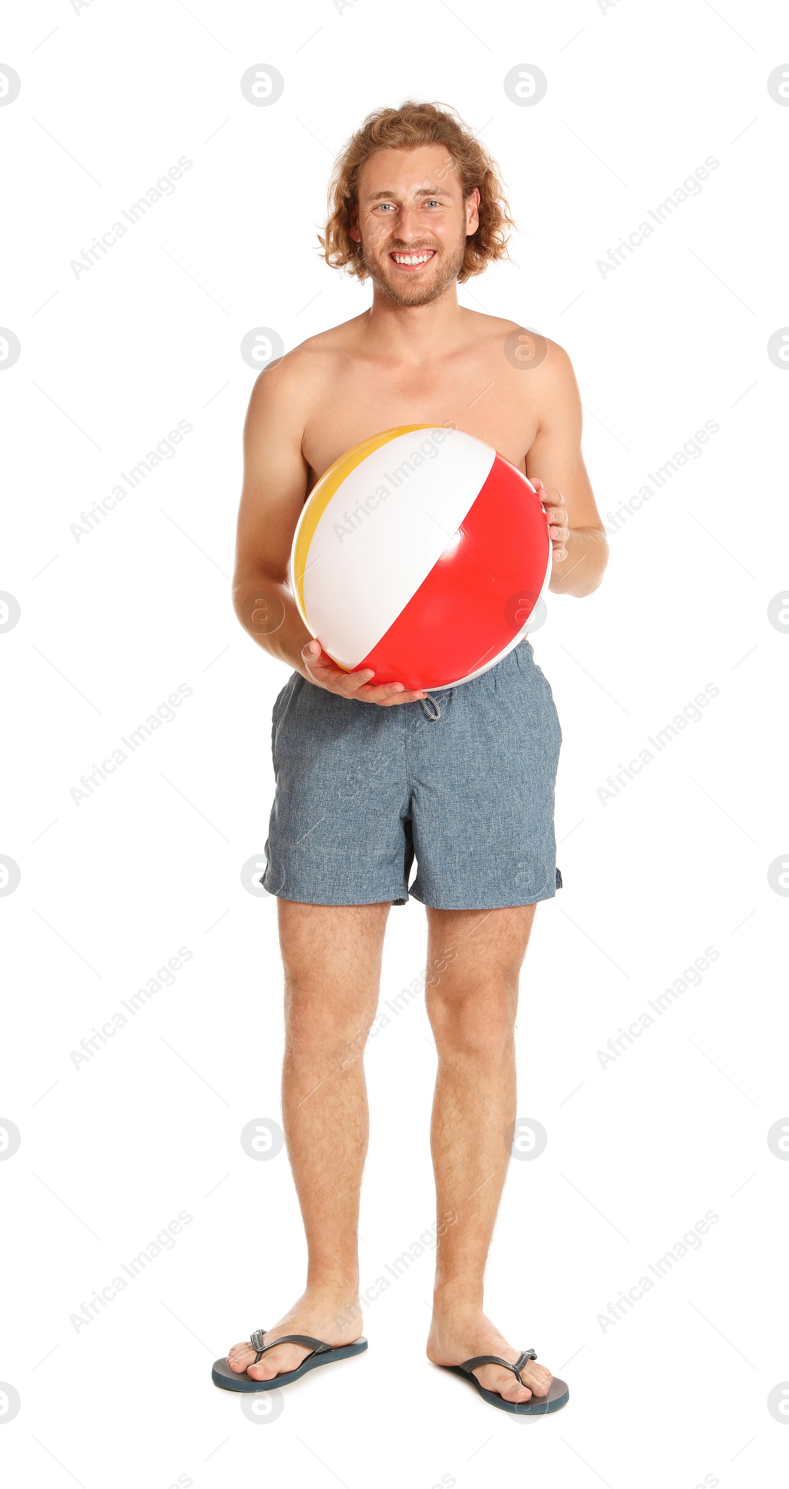 Photo of Attractive young man in beachwear with colorful inflatable ball on white background