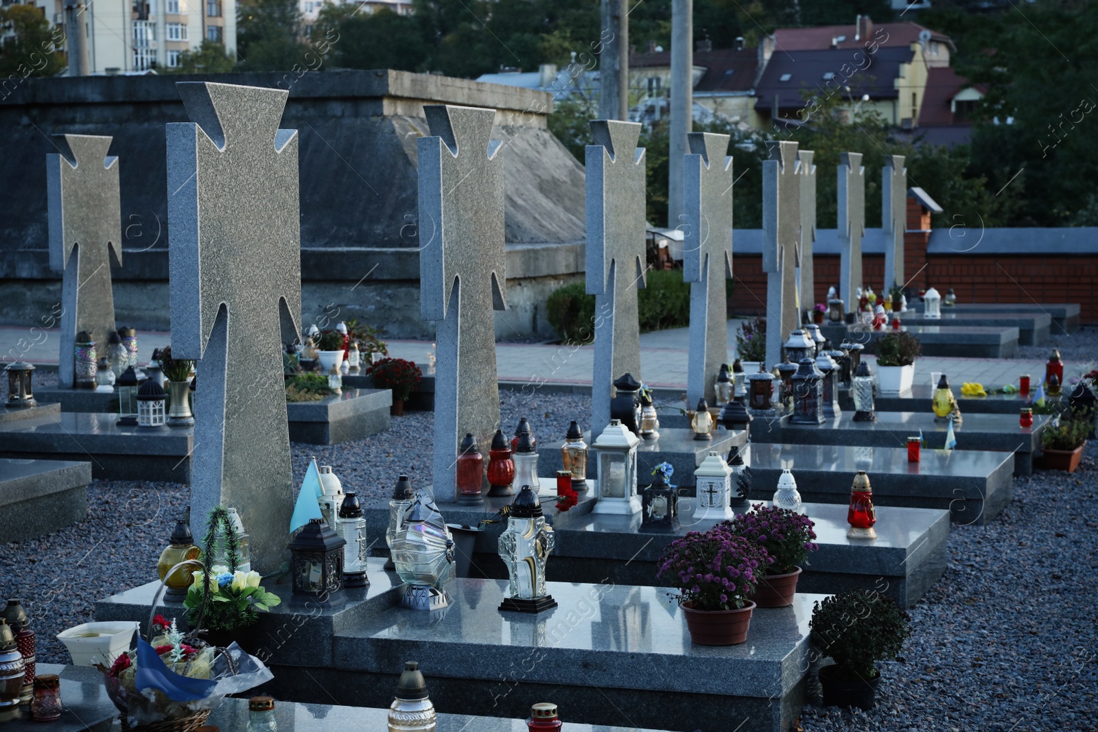 Photo of Many granite tombstones on cemetery. Funeral ceremony