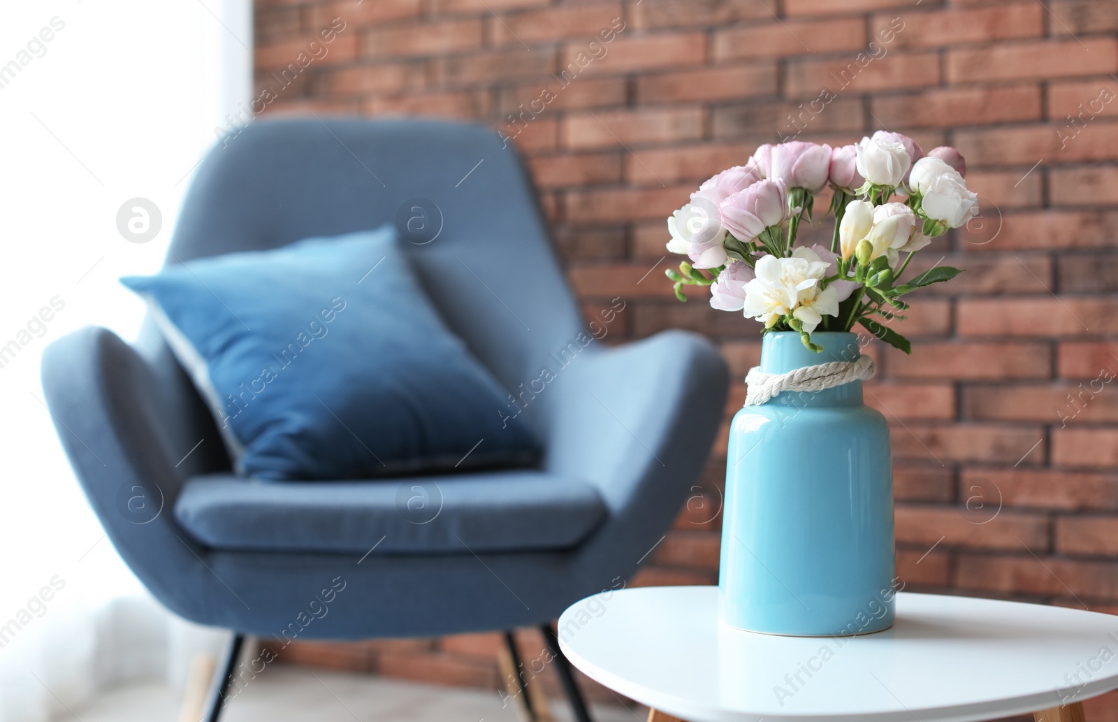 Photo of Vase with beautiful flowers on table indoors. Interior decor element