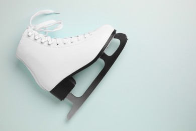 Photo of Pink ice skate on light background, top view. Space for text