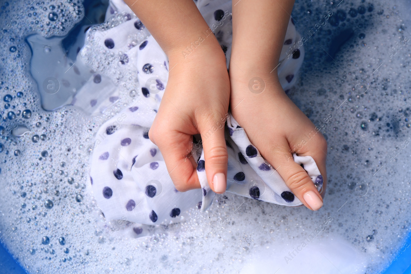 Photo of Woman washing garment in suds, closeup. Laundry