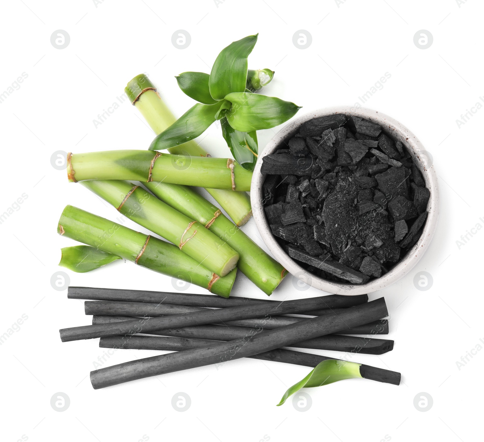 Photo of Fresh bamboo and charcoal on white background, top view