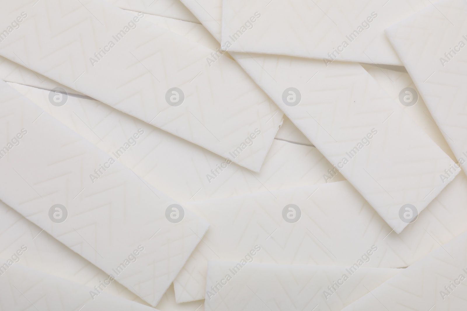 Photo of Sticks of white chewing gum as background, top view