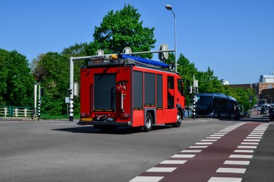 Photo of Modern red fire truck on city street