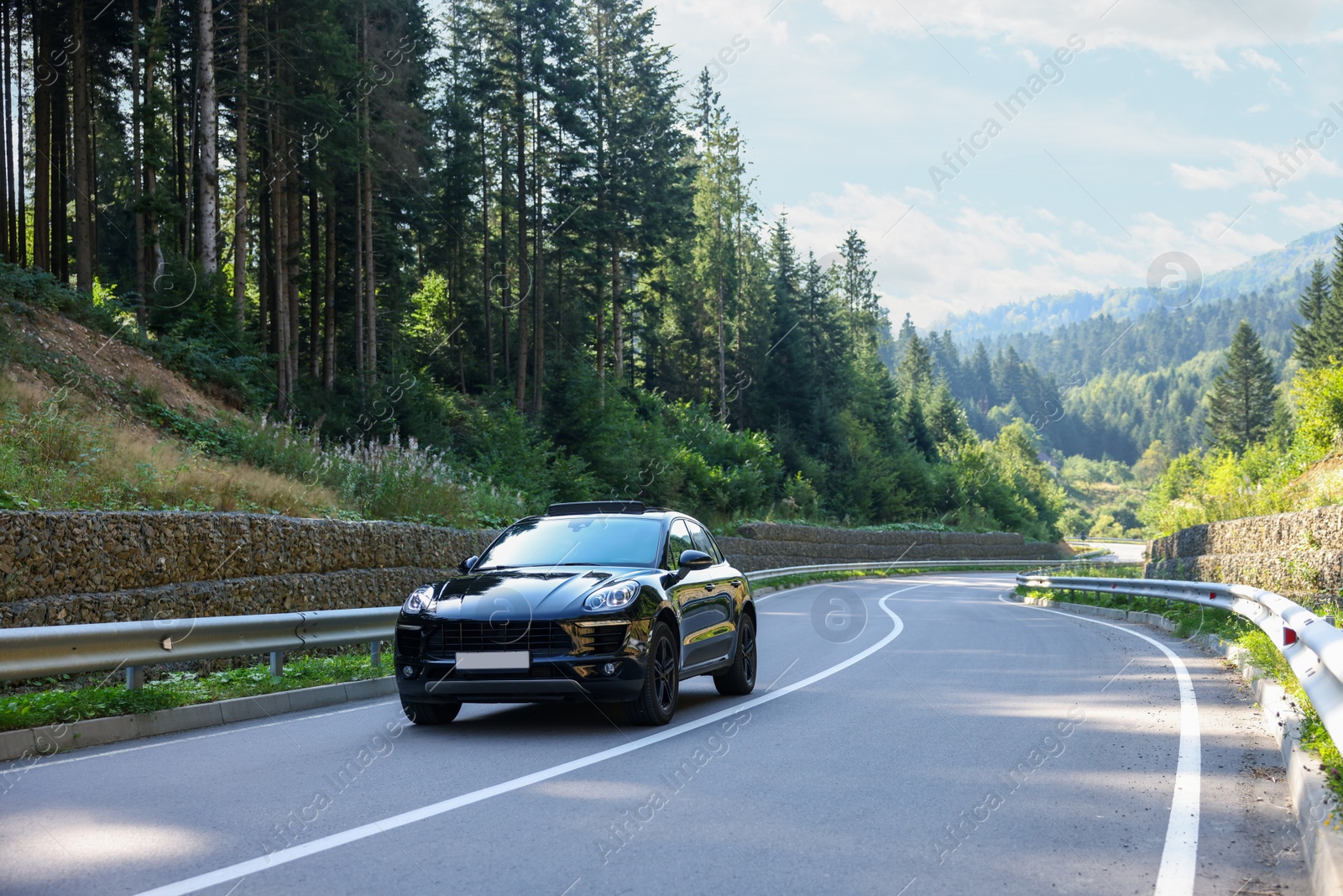 Photo of Picturesque view of asphalt road with modern black car outdoors