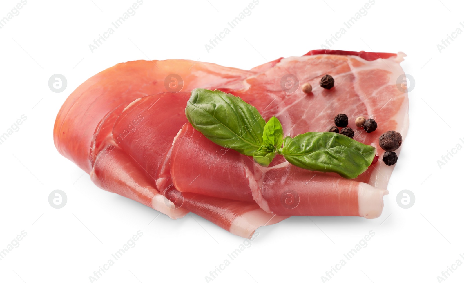 Photo of Slices of delicious jamon, spices and basil isolated on white