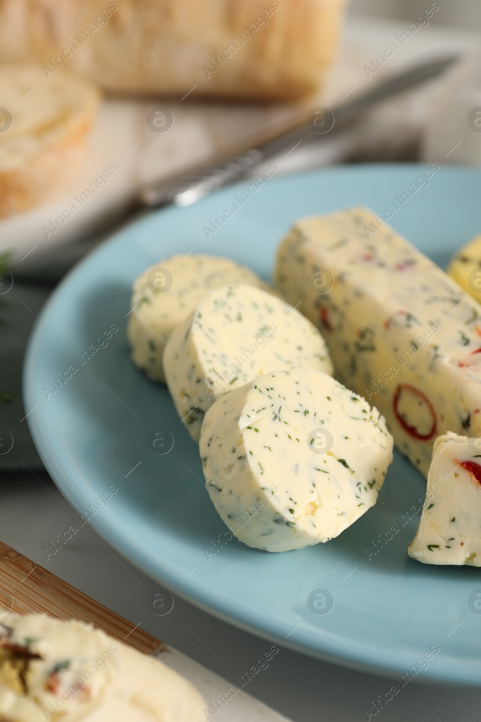 Photo of Tasty butter with herbs and spices on table, closeup