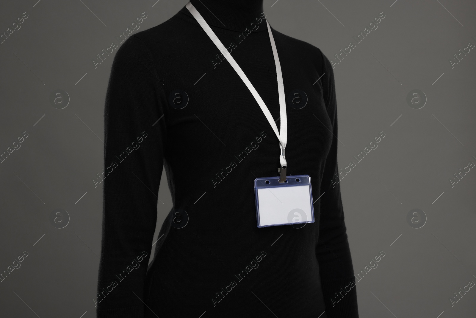 Photo of Woman with blank badge on grey background, closeup