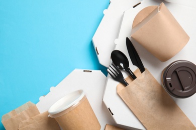 Different containers for mock up design on blue background, top view. Food delivery service