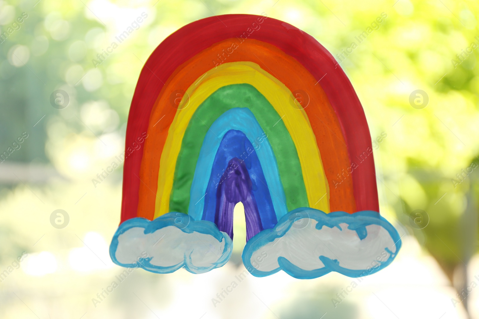 Photo of Picture of rainbow on window glass, closeup. Stay at home concept