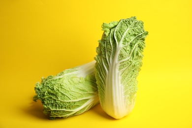 Photo of Fresh ripe cabbages on color background