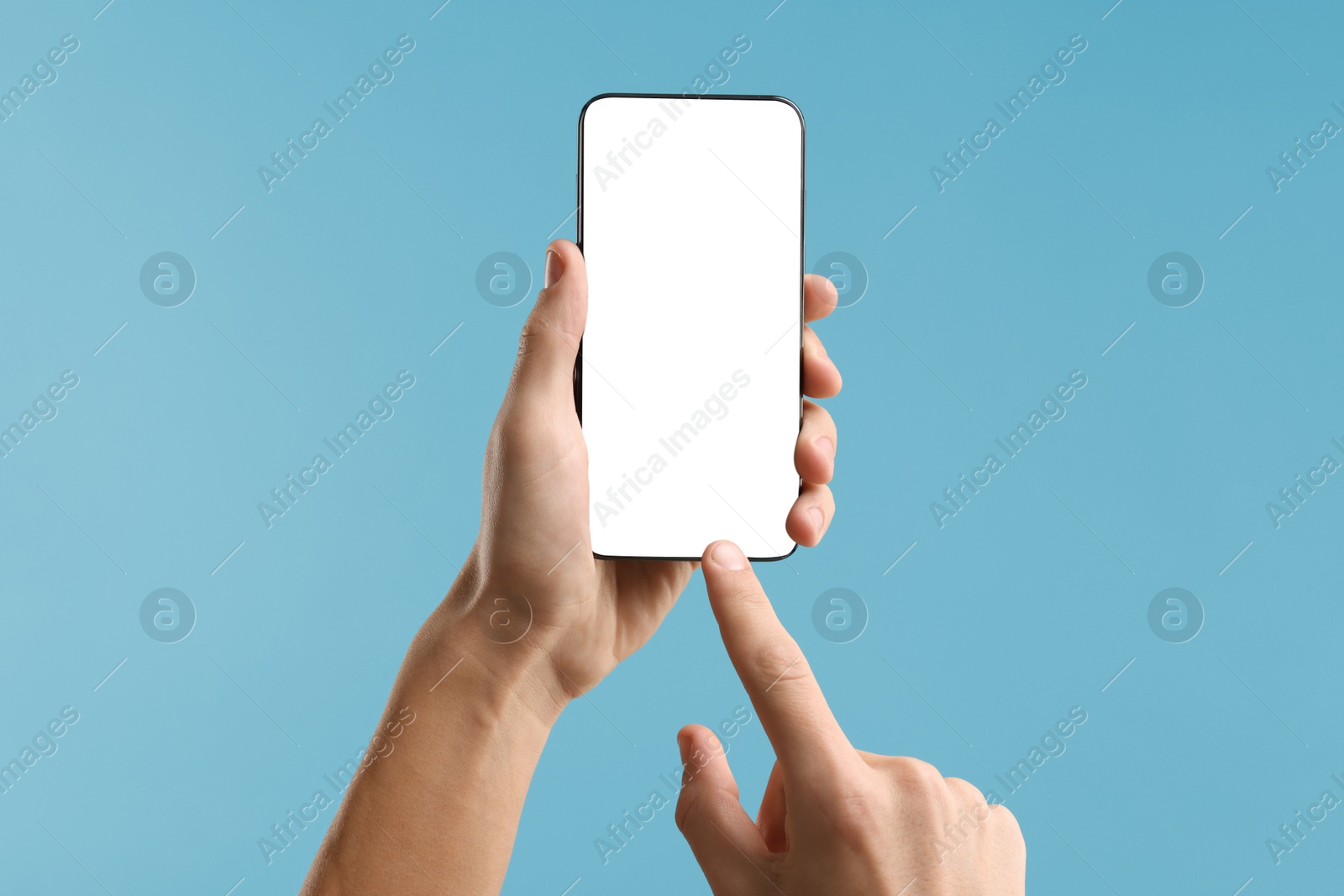 Photo of Man using smartphone with blank screen on light blue background, closeup. Mockup for design