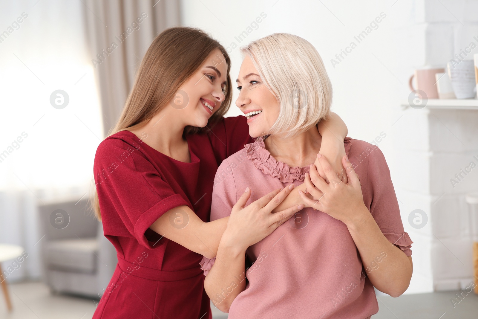 Photo of Portrait of mature woman and her daughter at home