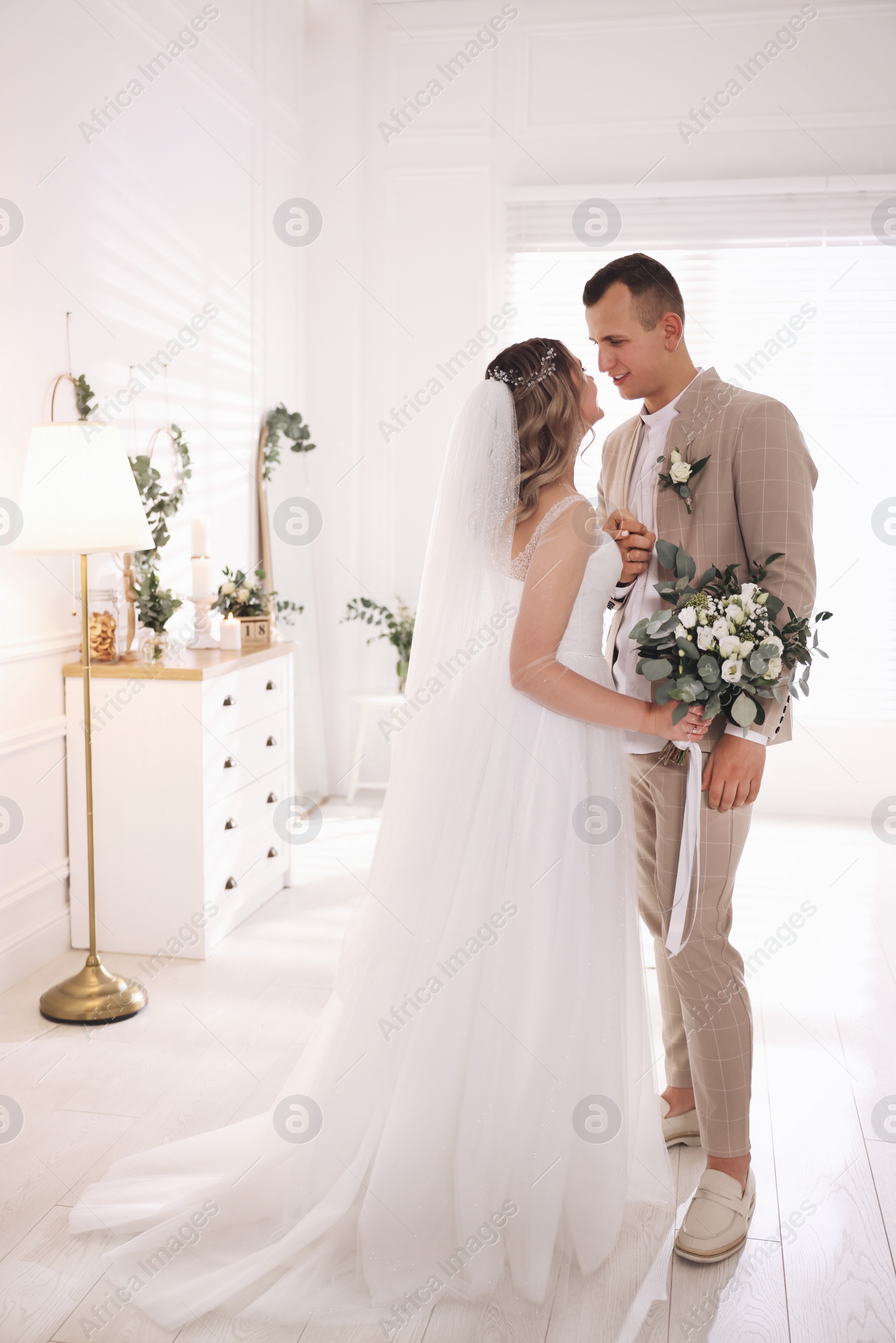 Photo of Happy bride and groom indoors. Wedding day