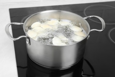 Photo of Cooking delicious dumplings in pot on cooktop
