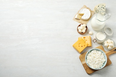 Different dairy products on white table, flat lay. Space for text