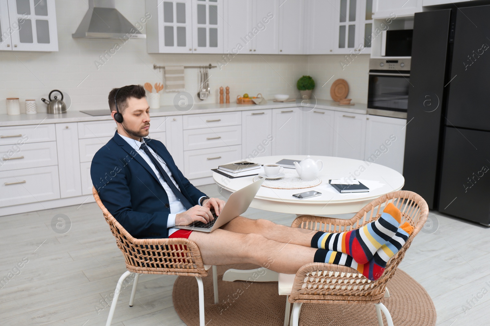 Photo of Businessman in underwear pretending to wear formal clothes during video call at home