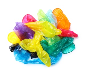 Pile of unrolled bright condoms on white background, top view. Safe sex