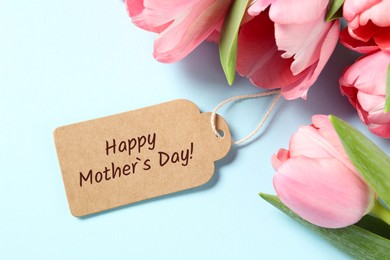 Image of Happy Mother's Day greeting label and beautiful tulip flowers on light blue background
