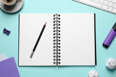 Flat lay composition with stylish notebook on light blue background