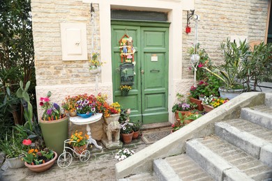 Photo of Beautiful house with decor and flowers near entrance