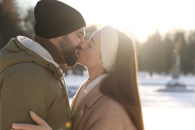 Photo of Beautiful happy couple in snowy park on winter day