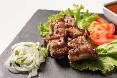 Tasty shish kebab served on slate plate, closeup