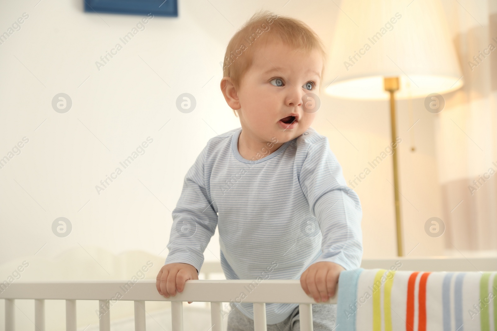 Photo of Cute little baby in crib at home