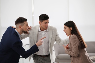Photo of Man setting his fighting colleagues apart in office