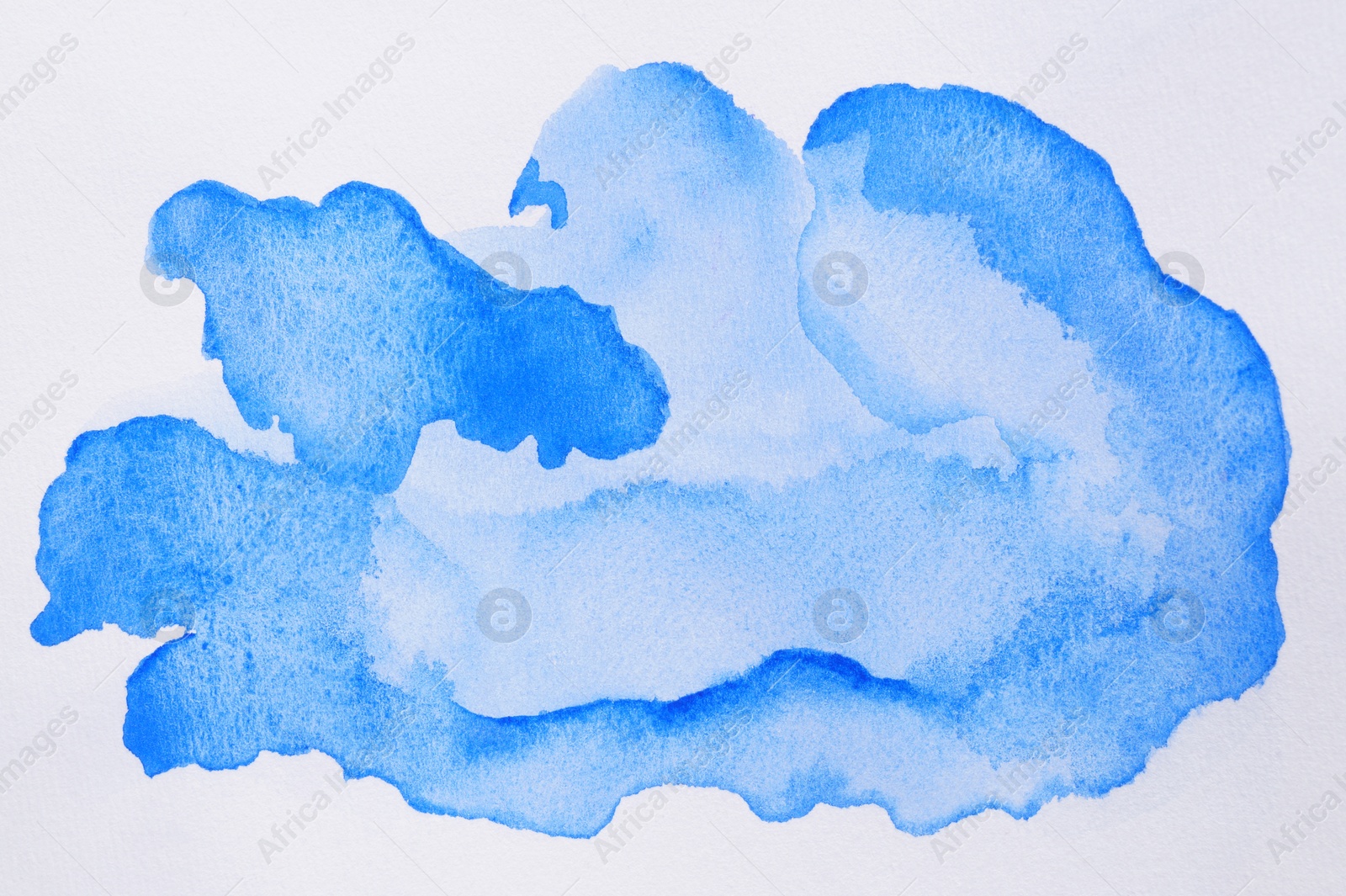 Photo of Abstract blue watercolor paint on white background, top view