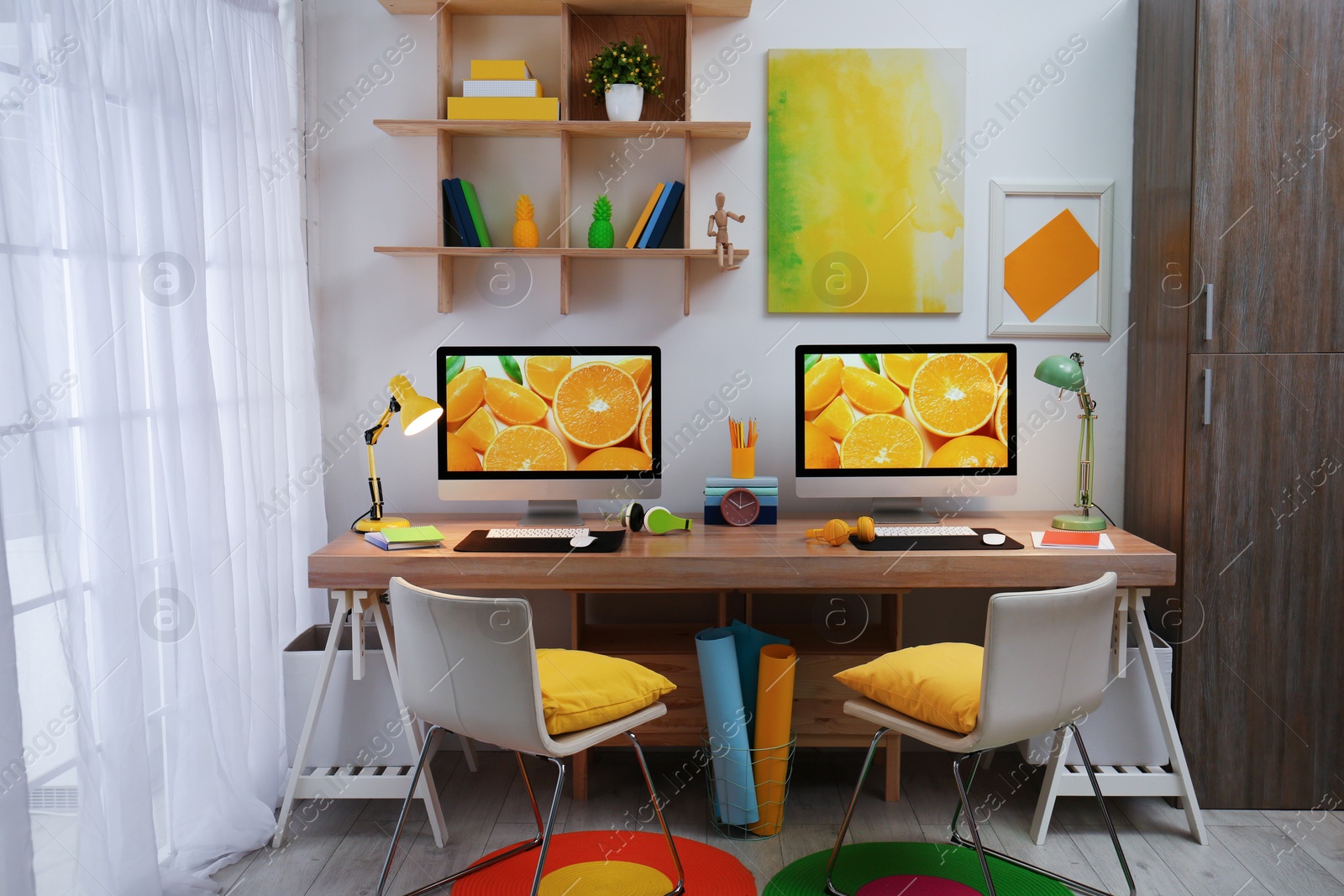 Photo of Modern workplace with large desk and computers in room. Stylish interior