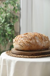 Freshly baked bread with tofu cheese on table indoors